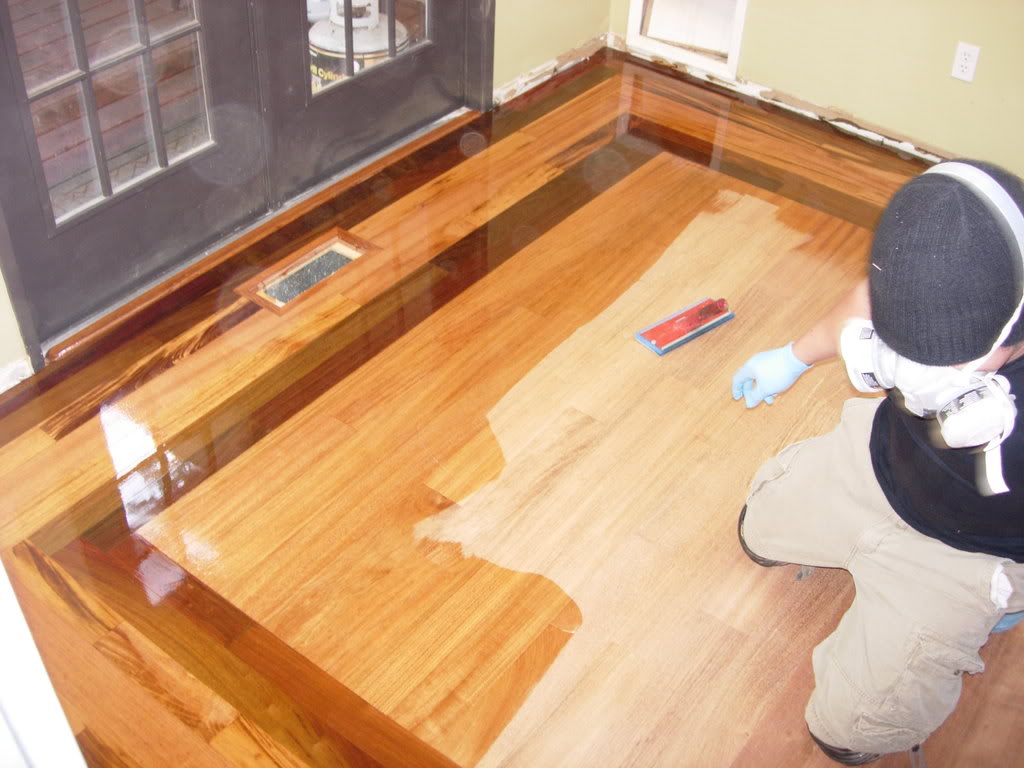 A Man Polishing a Wood Floor Surface