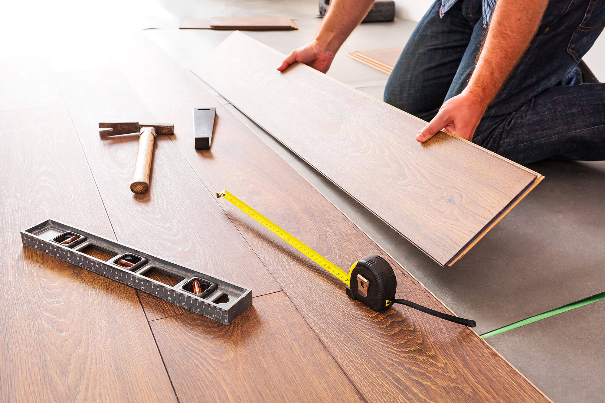 A Man Installing Laminate on the Floor